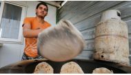 A Syrian refugee makes bread to sell at the Zaatari refugee camp in Mafraq, Jordan, January 8, 2015. Reuters/Muhammad Hamed