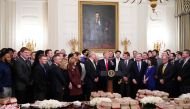 Donald Trump speaks behind a table of fast-food during an event in honor of the The North Dakota State Bison in the State Dining Room of the White House on March 4, 2019. AFP / Mandel Ngan