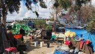 A homeless encampment made of tents and tarps lines the Santa Ana riverbed near Angel Stadium in Anaheim, California, January 25, 2018. AFP / Robyn Beck