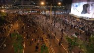 Protesters spill out into the main road near the government offices in the Admiralty area in Hong Kong on September 28, 2019, as activists mark the fifth anniversary of the 
