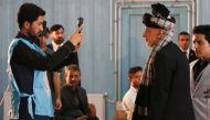 Afghan President Ashraf Ghani (R) casts his vote at a polling station during the presidential elections in Kabul, Afghanistan on September 28, 2019. Haroon Sabawoon - Anadolu