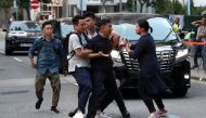 A protester is escorted by undercover police officers after he tried to stop Hong Kong Chief Executive Carrie Lam's motorcade in Hong Kong, China September 26, 2019. REUTERS/Athit Perawongmetha 