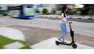 A woman rides a Neuron rental electric scooter in Singapore June 16, 2017. Reuters/Thomas White