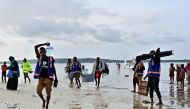 Staff and volunteers of Safari Doctors carry medical supplies to shore as they arrive to conduct a mobile clinic at Kiangwe in Lamu on June 17, 2019.  AFP / Tony Karumba 