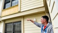 Derek Rouse points to an incomplete repair on the back of his home at Tinker Air Force Base, Oklahoma, U.S. May 1, 2019. Picture taken May 1, 2019. Reuters/Nick Oxford