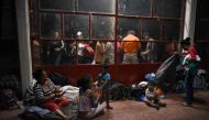 Central American migrants -taking part in a caravan called Migrant Viacrucis- rest at a sports center field in Matias Romero, Oaxaca state, Mexico on April 2, 2018. AFP / Victoria Razo