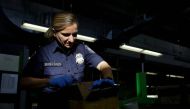 A US Customs and Border Protection officer inspects a package arriving at the International Mail Facility at O'Hare International Airport in Chicago, Illinois, U.S. November 29, 2017. Reuters/Joshua Lott