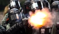 A riot police fires tear gas to disperse anti-government protesters after a march in Hong Kong, China, September 29, 2019. Reuters / Athit Perawongmetha