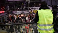 A yellow vest stands as protestors stay inside the Italie Deux shopping mall in Paris during a demonstration called by the Extinction Rebellion environmental activist movement, on October 5, 2019. AFP / Lucas Barioulet 
