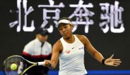 Naomi Osaka of Japan hits a return during her women's singles semi-final match against Caroline Wozniacki of Denmark at the China Open tennis tournament in Beijing on October 5, 2019. / AFP / Leo Ramirez 