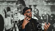 French-born artist JR speaks during an interview prior to the opening of his exhibition 