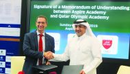 Aspire Academy Director General Ivan Bravo and Executive Director of Qatar Olympic Academy, Saif Mohammed Al Nuaimi exchanging documents during the MoU signing ceremony.