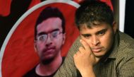 A Bangladeshi student sits during a protest in Dhaka on October 7, 2019, next to a portrait of Abrar Fahad, who was allegedly beaten to death by ruling party activists. AFP / Munir Uz Zaman 