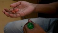 In this photograph taken on September 26, 2019, a tuberculosis (TB) patient holds his daily dose of medicine at a DOTS (directly observed treatment, short-course) Centre in New Delhi. AFP / Money SHARMA