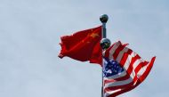FILE PHOTO: Chinese and US flags flutter near The Bund, before US trade delegation meet their Chinese counterparts for talks in Shanghai, China July 30, 2019. REUTERS/Aly Song
