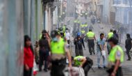 Police officers clean up the remains of a barricade after a protest against Ecuador's President Lenin Moreno's austerity measures in Quito, Ecuador, October 8, 2019. REUTERS/Ivan Alvarado