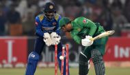Pakistan's captain Sarfraz Ahmed (R) is bowled out as Sri Lanka's wicketkeeper Minod Bhanuka looks on during the second Twenty20 International cricket match between Pakistan and Sri Lanka at the Gaddafi Cricket Stadium in Lahore on October 7, 2019. (AFP /