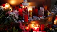 People place candles at central market square in Halle, Germany October 10, 2019, after two people were killed in a shooting. REUTERS/Fabrizio Bensch