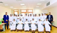 The students participating in the financial literacy program posing for a group picture with the officials.