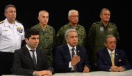 This handout image obtained courtesy of the Ecuadoran Presidency Press Office on October 7, 2019, shows Ecuadoran President Lenin Moreno (C) speaking in a national radio and television network broadcast in Guayaquil, Ecuador, alongside Vice President Otto