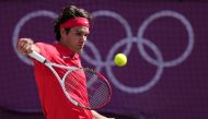 FILE PHOTO: Switzerland's Roger Federer returns the ball to Britain's Andy Murray during their London 2012 Olympic Games men's singles gold medal tennis match at Wimbledon in south London.  AFP / CARL COURT