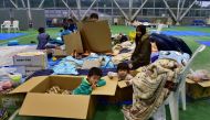 A family rest at an evacuation shelter in Nagano on October 14, 2019. AFP / Kazuhiro Nogi 