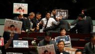 A pro-democracy lawmaker is escorted by security from the Legislative Council, as Hong Kong's Chief Executive Carrie Lam takes questions from lawmakers regarding her policy address, in Hong Kong, China October 17, 2019. REUTERS/Umit Bektas