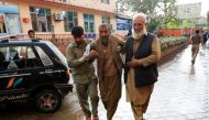Men carry an injured person to a hospital after a bomb blast at a mosque, in Jalalabad, Afghanistan October 18, 2019. Reuters/Parwiz