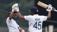 India's Rohit Sharma (R) celebrates his century (100 runs) with teammate Ajinkya Rahane during the first day of the third and final Test match between India and South Africa at the Jharkhand State Cricket Association (JSCA) stadium in Ranchi on October 19