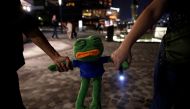 People holding a toy form a human chain during an anti-government protest in Hong Kong, China, October 18, 2019. REUTERS/Umit Bektas