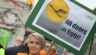 (FILES) This file photo taken on November 6, 2015 shows a cabin staff of German airline Lufthansa holding a placard during a demonstration outside the airport in Frankfurt am Main, western Germany. AFP / DANIEL ROLAND