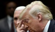 US President Donald Trump (R) and Vice President Mike Pence listen during a conference call with the International Space Station on October 18, 2019 in Washington, DC. Win McNamee/Getty Images/AFP
