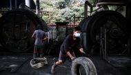 Workers operate furnaces at a tyre pyrolysis plant in Kulai, Johor, Malaysia August 7, 2019. Picture taken August 7, 2019. Reuters/Edgar Su
 