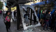 People wait to take a bus in Santiago, Chile on October 21, 2019.  AFP / Pedro Ugarte
