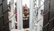 A girl who crossed the Canada-US border with her family claiming refugee status in Canada at a temporary detention centre in Blackpool, Quebec on August 5, 2017. AFP / Geoff Robins