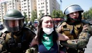 Riot police detain a demonstrator during a protest in Santiago, Chile, on October 21, 2019. AFP / Pablo Vera 