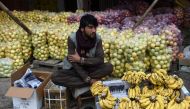 A fruit vendor waits for costumers at the fruit market in Kabul on October 22, 2019. AFP / Wakil Kohsar 