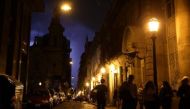 People walk on a street as lightning illuminates the sky in Buenos Aires, Argentina, October 18, 2017. Reuters / Marcos Brindicci