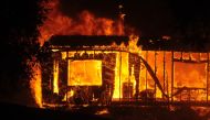 Flames and smoke rise after a fire broke out at Geyserville town in Sonoma County, California, United States on October 25, 2019. Authorities have ordered residents of a small town in the state of California's wine country to evacuate as strong winds fuel