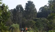 People run in Karura forest, Nairobi on September 17, 2019.  AFP / Simon Maina 
