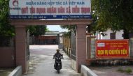 A motorist leaves a People's Credit Fund office, from where local residents can borrow money in Dien Thinh commune of Vietnam's Nghe An province on October 28, 2019. AFP / NHAC NGUYEN