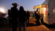 People wait for food from a mobile vendor at the Utah Navajo Fair in Bluff, Utah, US, October 28, 2017. Reuters/Andrew Cullen