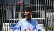 In this file photo taken on September 28, 2019 pro-democracy activist and South Horizons Community Organiser Joshua Wong stands in front of the Central Government Complex before the announcement of his run for 2019 District Council elections in Hong Kong.
