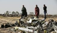 Ethiopian police officers walk past the debris of the Ethiopian Airlines Flight ET 302 plane crash near the town of Bishoftu near Addis Ababa, Ethiopia, March 12, 2019. Reuters / Baz Ratner
