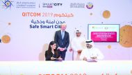 Minister of Commerce and Industry, H E Ali bin Ahmed Al Kuwari (standing right), Abdulla Ahmad Al Ali (right), Director of Information Technology at MoCI, with Lana Khalaf (left), Country Manager at Microsoft Qatar, during the signing ceremony at QITCOM, 