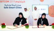 Minister of Transport and Communications, H E Jassim bin Saif Al Sulaiti, (standing left), and Acting Chief Executive Officer of QNB Group, Abdullah Mubarak Al Khalifa (standing right), witnessing  the MoU signing held on the sidelines of QITCOM 2019 yest