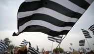 Activists and supporters of Islamic political party Jamiat Ulema-e-Islam (JUI-F) wave flags during anti-government 