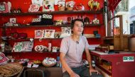 This photo taken on June 6, 2019 shows shopkeeper Louis To posing for a photo at his shop on Cheung Chau Island in Hong Kong. AFP / Isaac Lawrence 