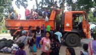 Residents, whose village were affected by a landslide due to a 6.5-magnitude earthquake, disembark from a government truck at a school compound in Makalila town, north Cotabato province, on November 1, 2019, a day after a powerful earthquake struck Mindan