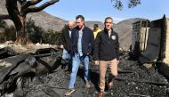 From left: L.A. Mayor Eric Garcetti (L) and California Governor Gavin Newsom view a burned and home along Tigertail Road in Brentwood California October 29, 2019. Wally Skalij/Pool via REUTERS